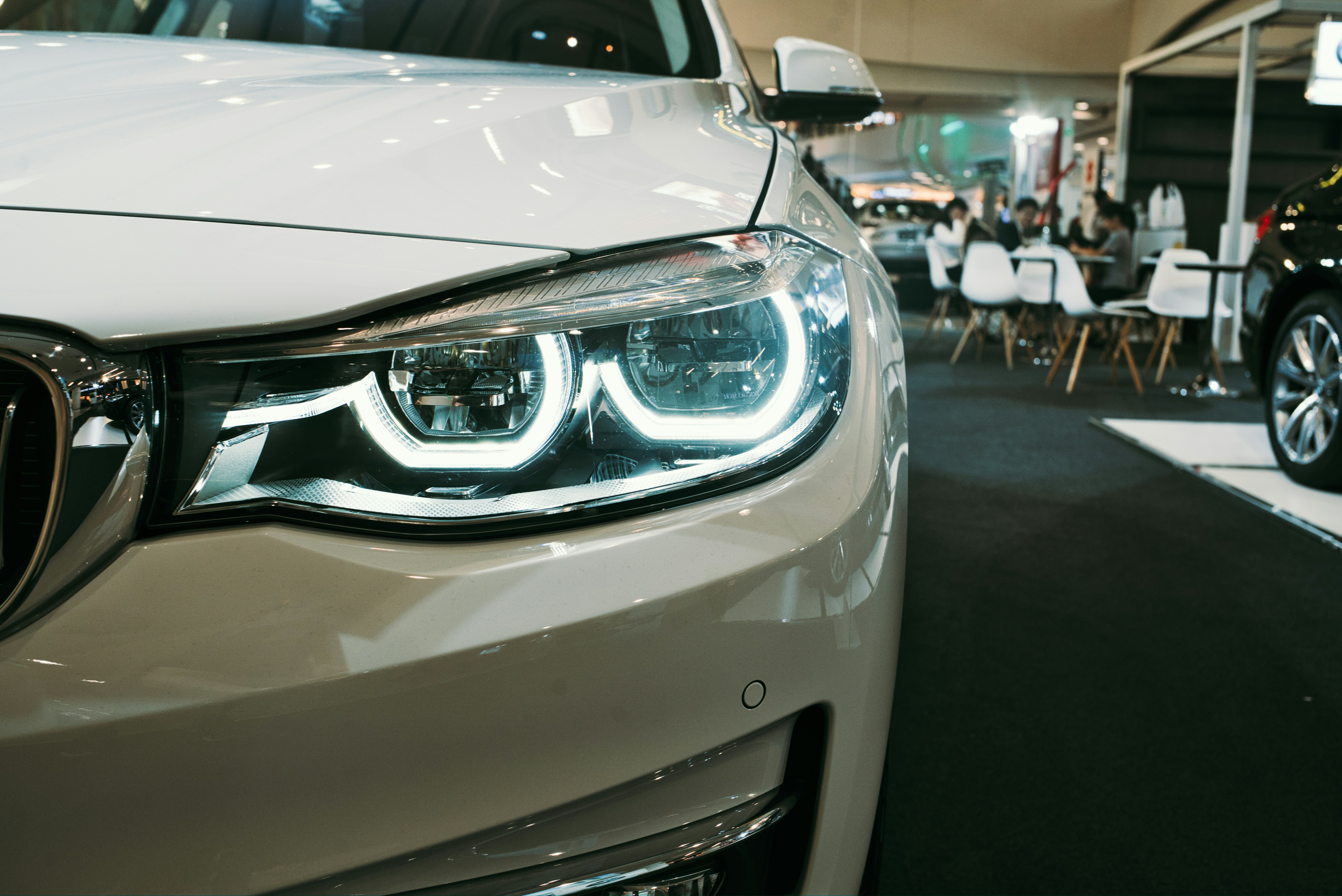 Car showroom closeup of white sedan